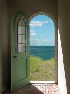 2722495-arched-doorway-opening-onto-a-grassy-beach-with-sunlight-streaming-in